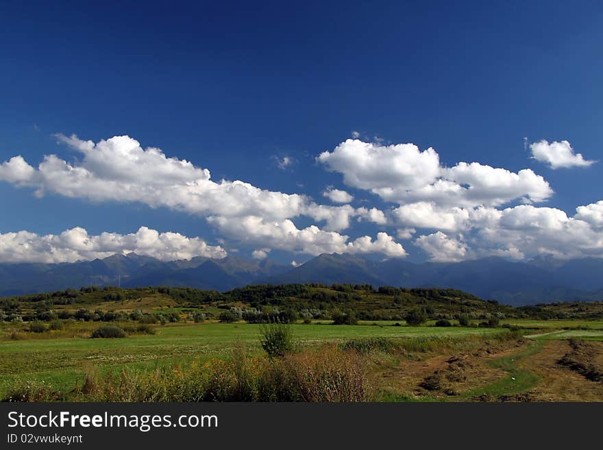 White clouds over distant mountains