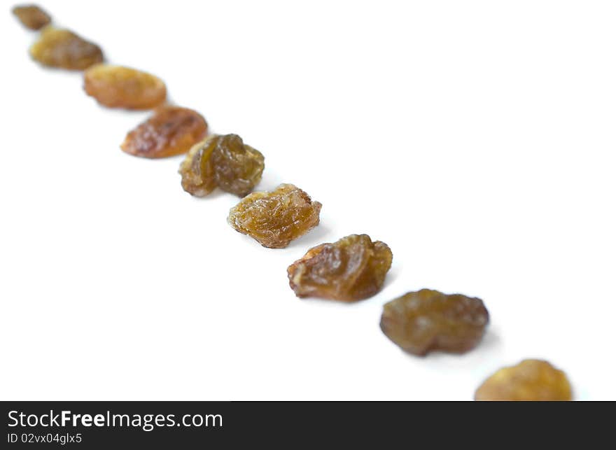 Line of raisins isolated over white background