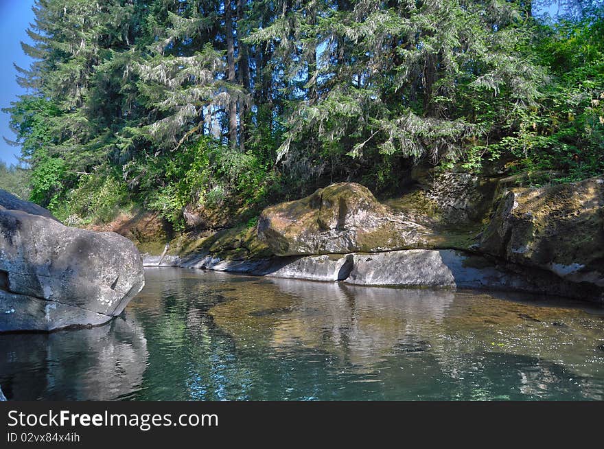 A rocky river with waters so calm it is almost like a lake. Taken in Oregon. HDR. A rocky river with waters so calm it is almost like a lake. Taken in Oregon. HDR.