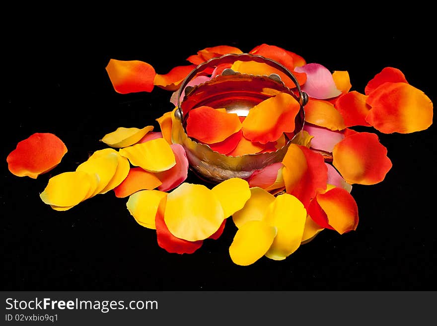 Silver basket on rose textile petals