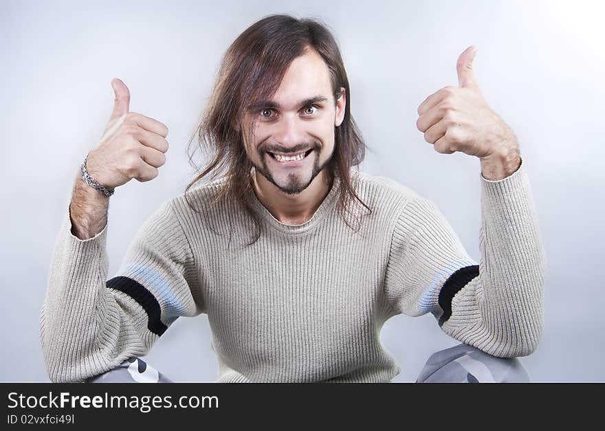 Energy young man holds fingers upwards