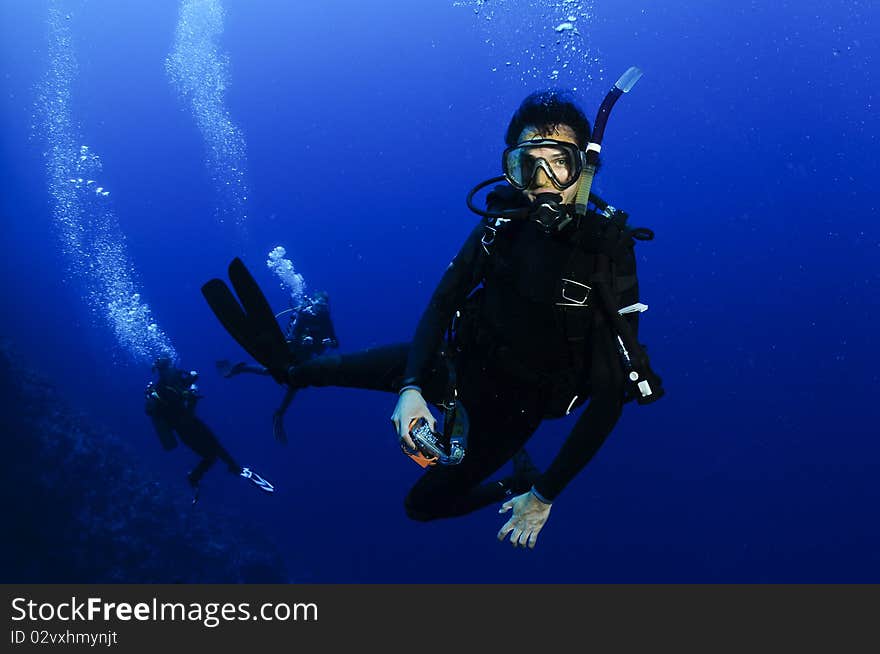 Scuba diver comes down bells in blue hole, Dahab, Egypt