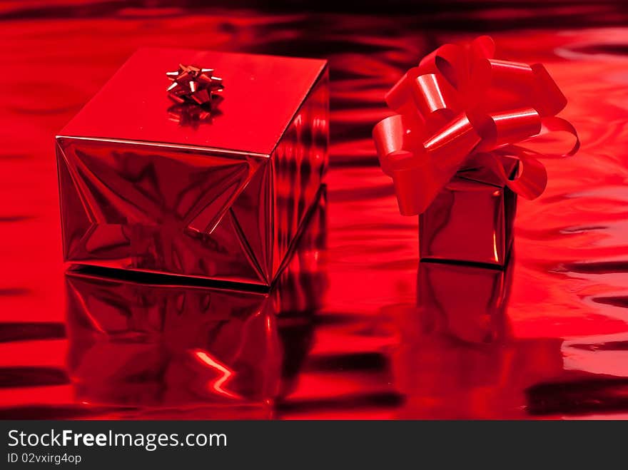 Two red christmas presents. Red background