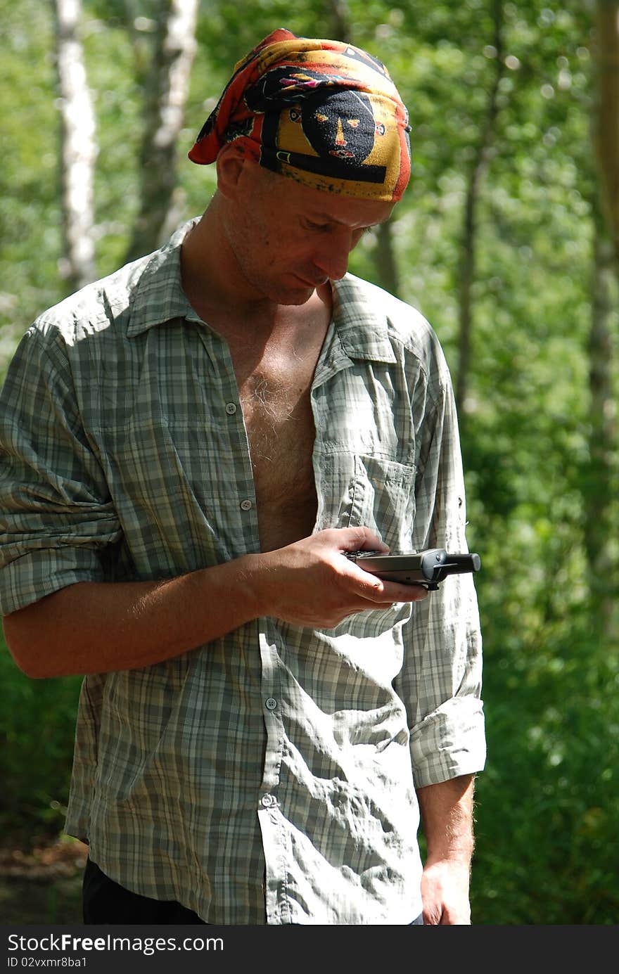 Kamchatka forest. Hiker checking position with gps. Kamchatka forest. Hiker checking position with gps