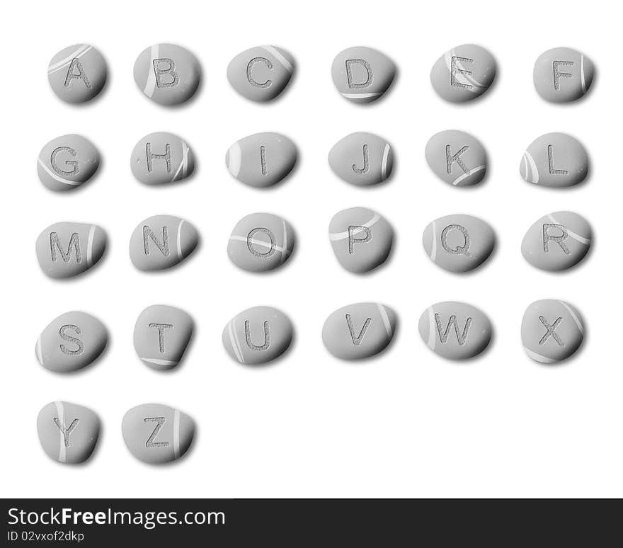 Letters of the alphabet stone-carved on pebbles on a white background. Letters of the alphabet stone-carved on pebbles on a white background.