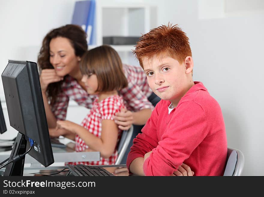 Teacher and children learning to use computer. Teacher and children learning to use computer