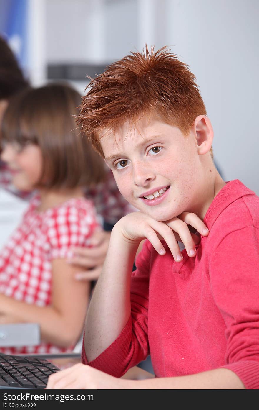 Young red-haired boy in classroom. Young red-haired boy in classroom