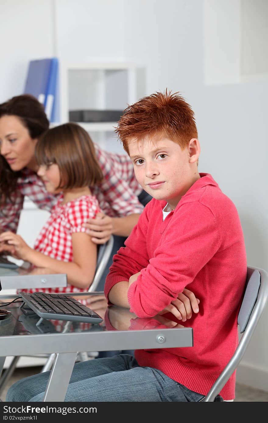 Teacher and children learning to use computer. Teacher and children learning to use computer