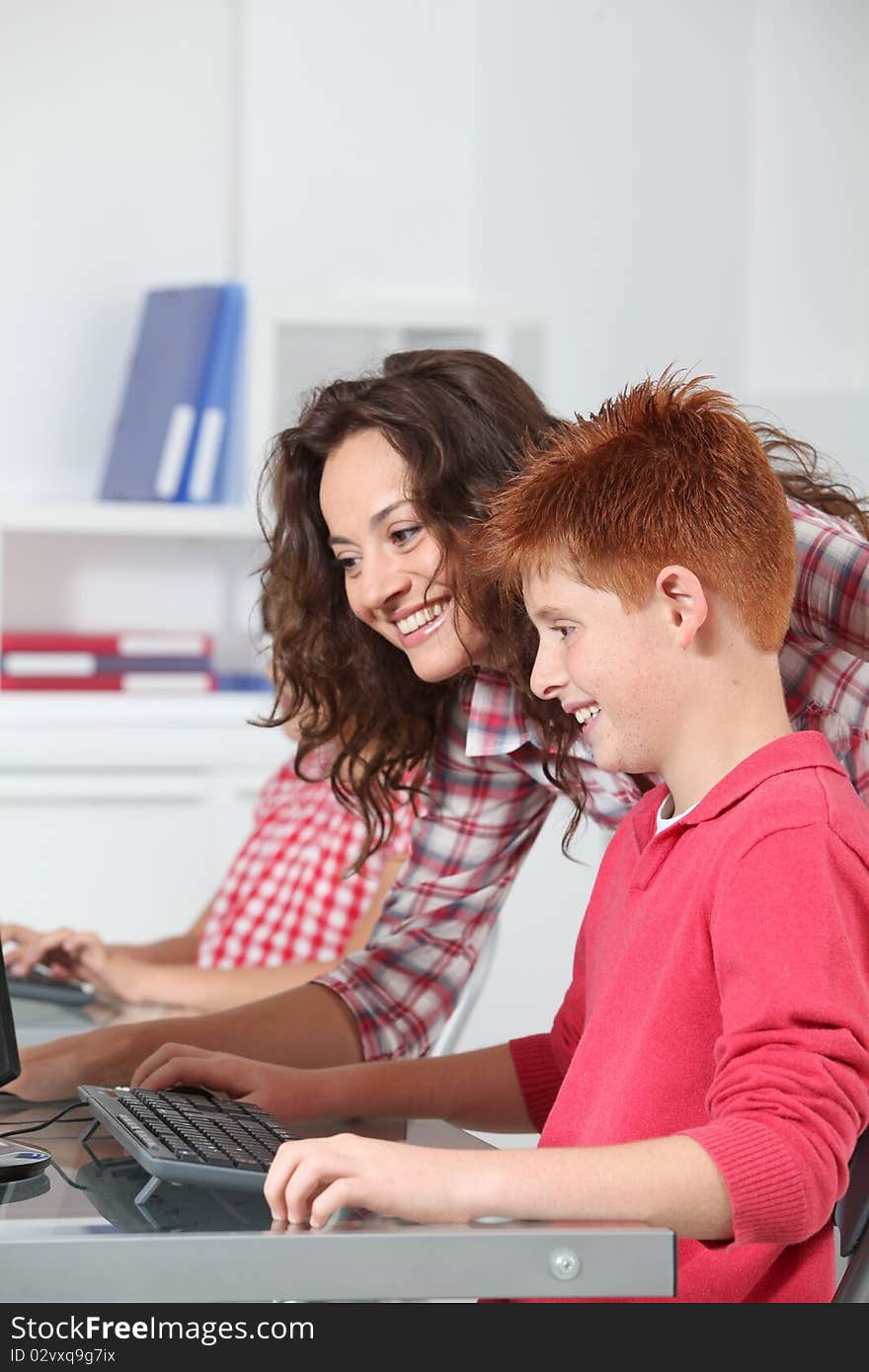 Teacher and children learning to use computer. Teacher and children learning to use computer