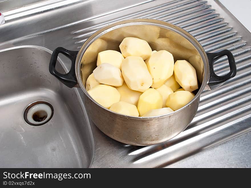 Pot with potatoes. On a kitchen. Pot with potatoes. On a kitchen