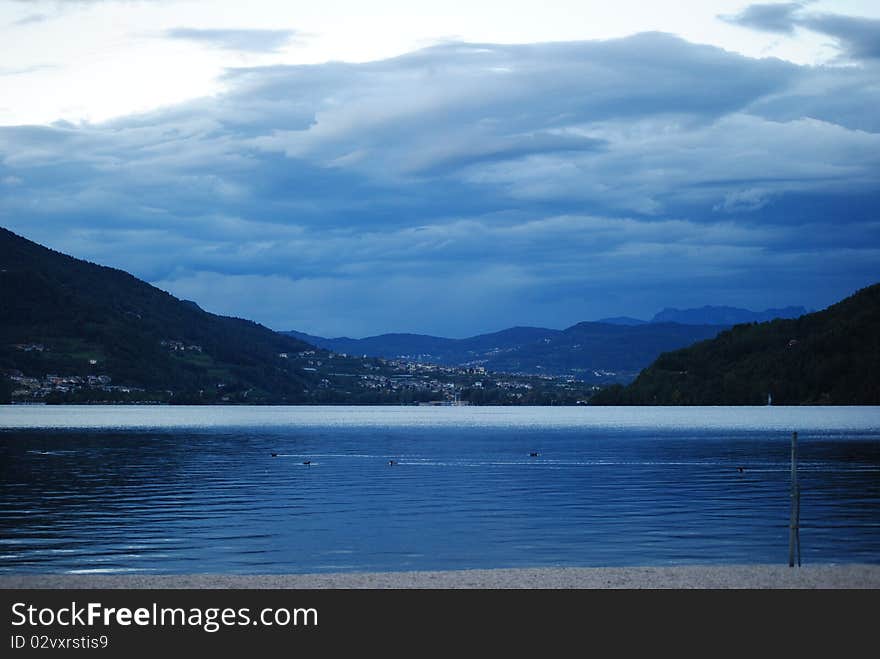 Caldonazzo's lake topped by dark clouds