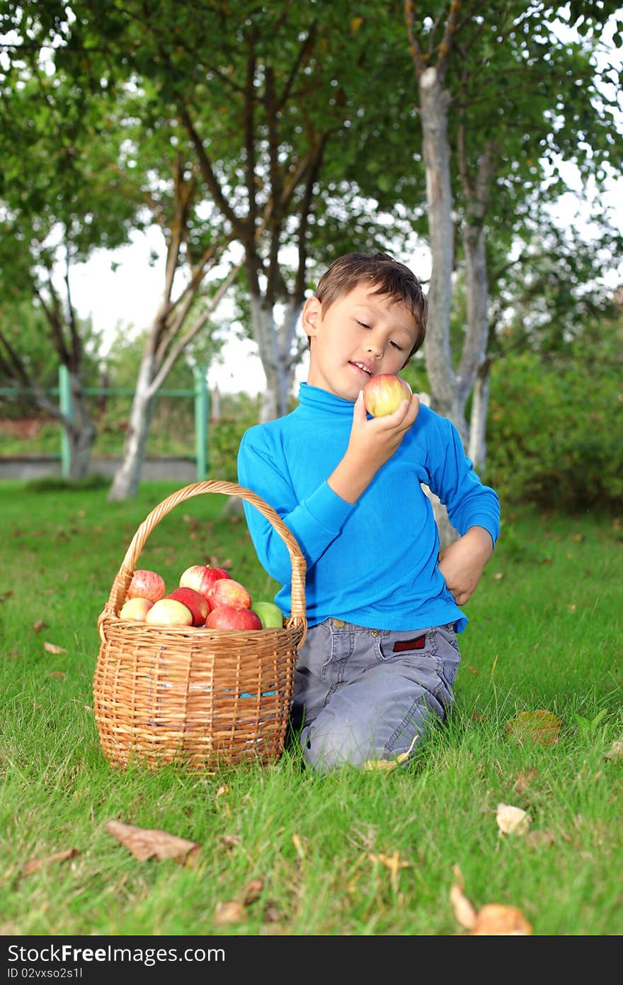 Little boy posing outdoors with apples. Little boy posing outdoors with apples