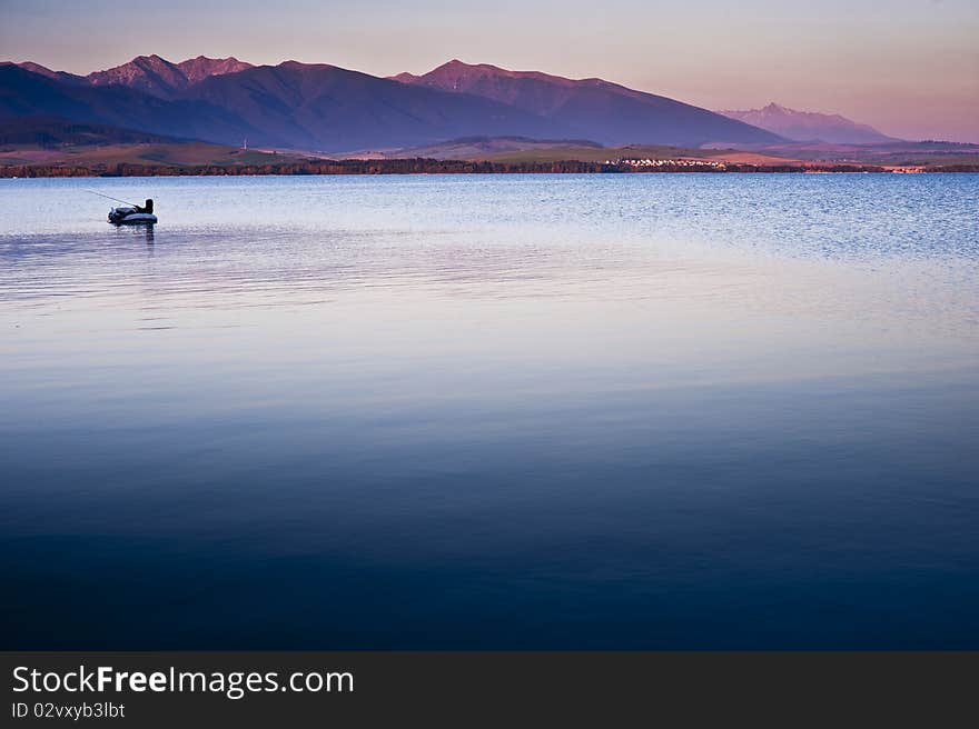 Fishermn on a boat in late summer evening. Fishermn on a boat in late summer evening