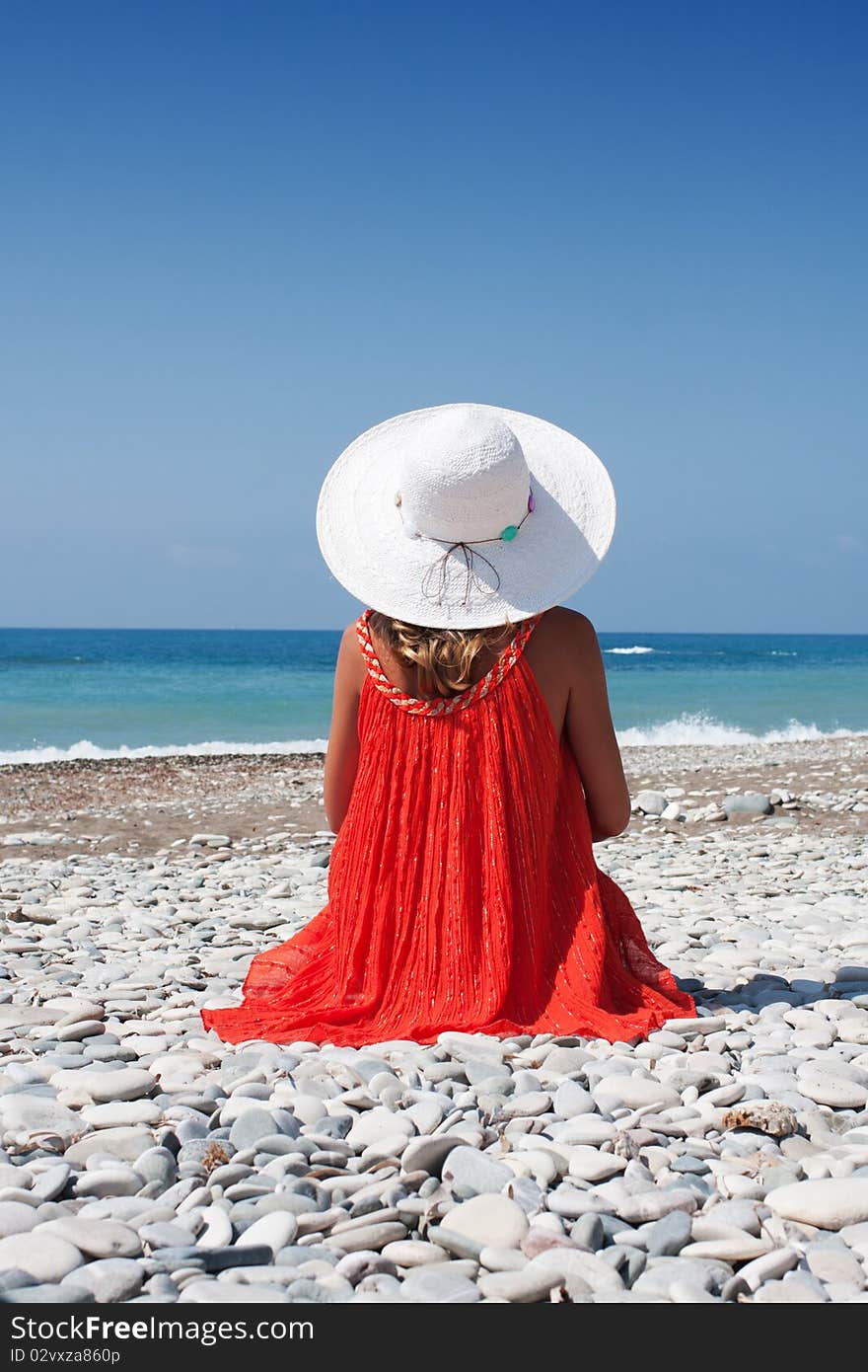 Woman in a hat by the sea