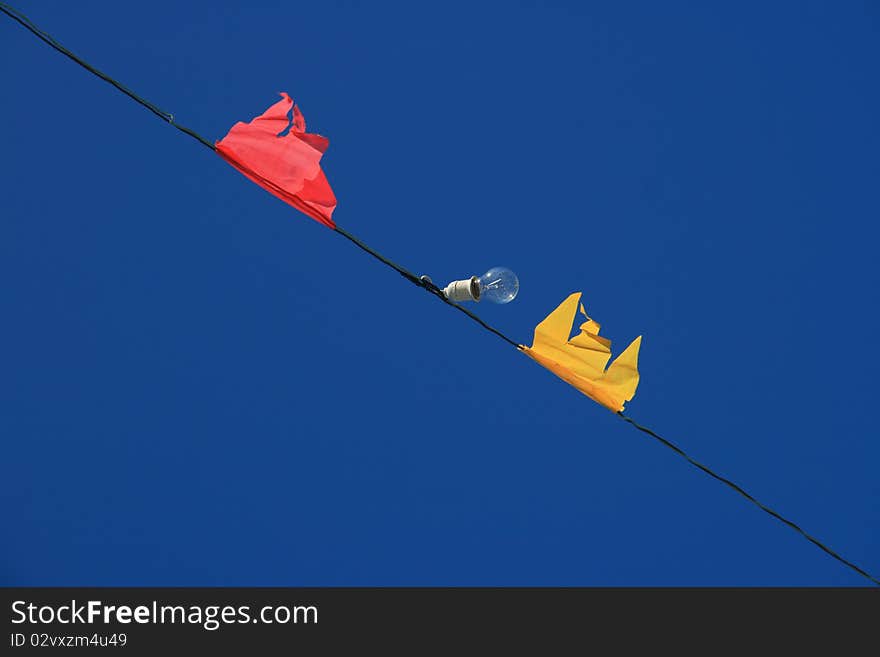 Flags and lamp in sky background