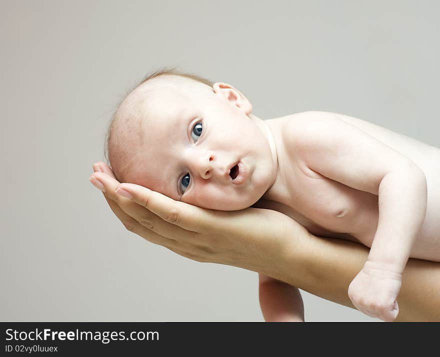 The kid lies on heat, a gentle hand of mum. The kid lies on heat, a gentle hand of mum