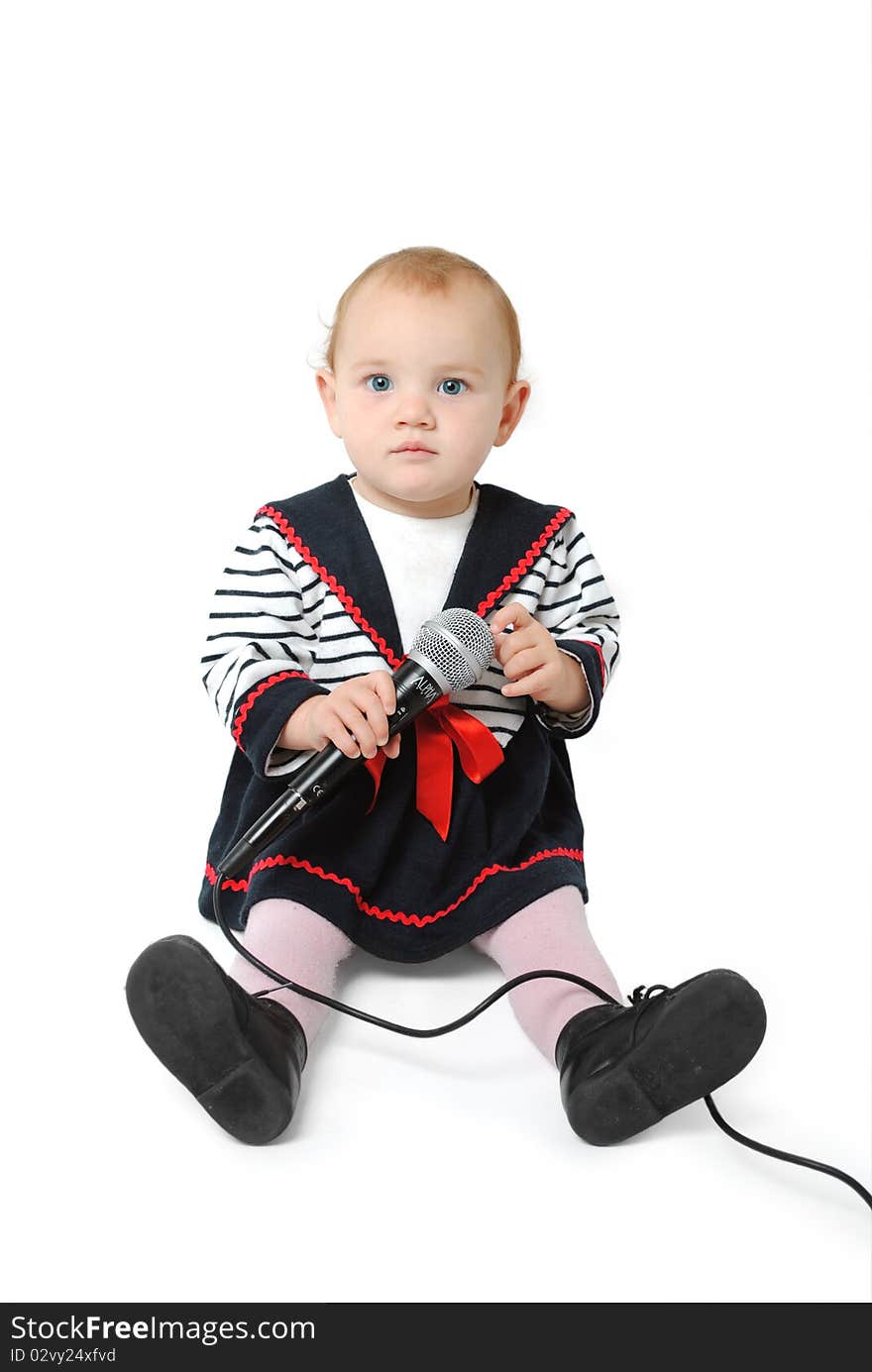 Sweet one year old baby girl with blue eyes singing with a microphone in her hand isolated on a white background. Sweet one year old baby girl with blue eyes singing with a microphone in her hand isolated on a white background