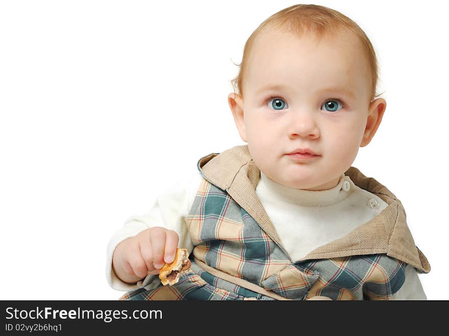 Sweet one year old baby girl with blue eyes with a cookie in her hand isolated on a white background. Sweet one year old baby girl with blue eyes with a cookie in her hand isolated on a white background