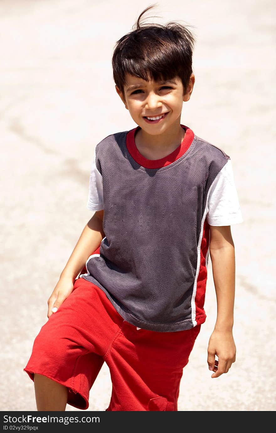 Young boy posing in style, looking at camera