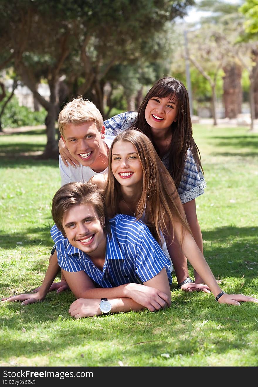 Beautiful group of friends at the park having fun during summer vacations