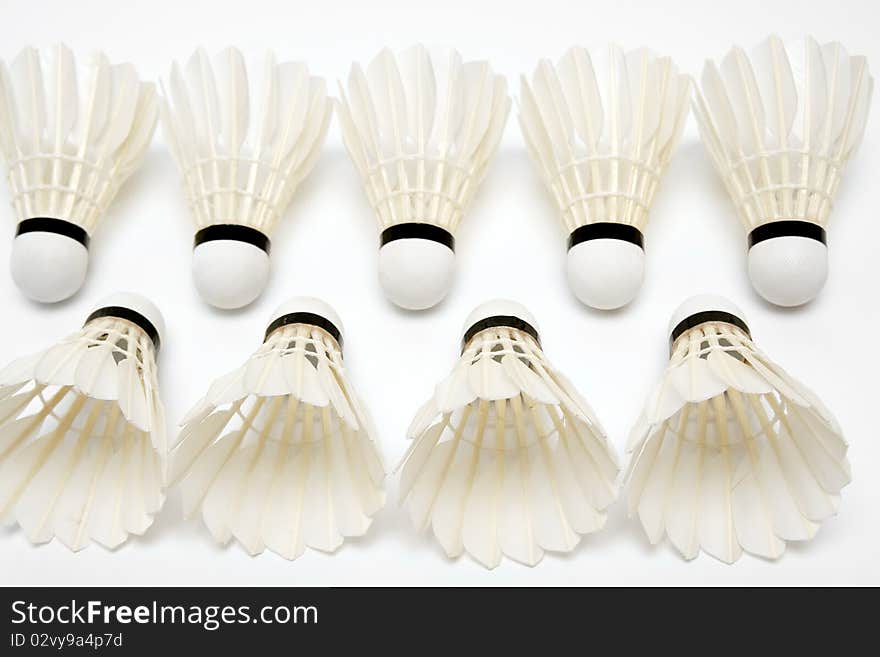 Two rows of badminton shuttlecocks on white background. Two rows of badminton shuttlecocks on white background