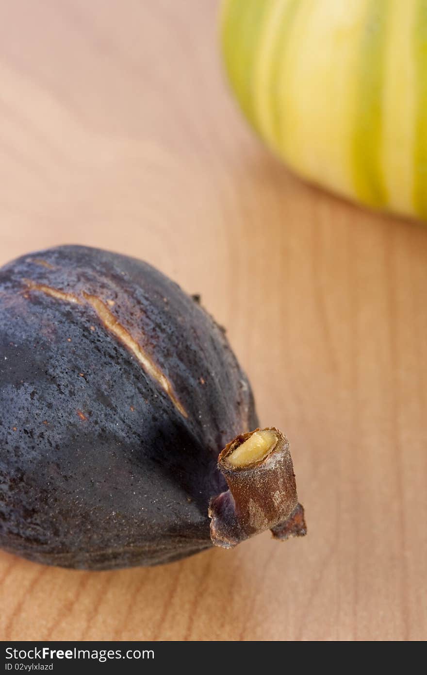 Ripe fruits of a fig on a wooden table.