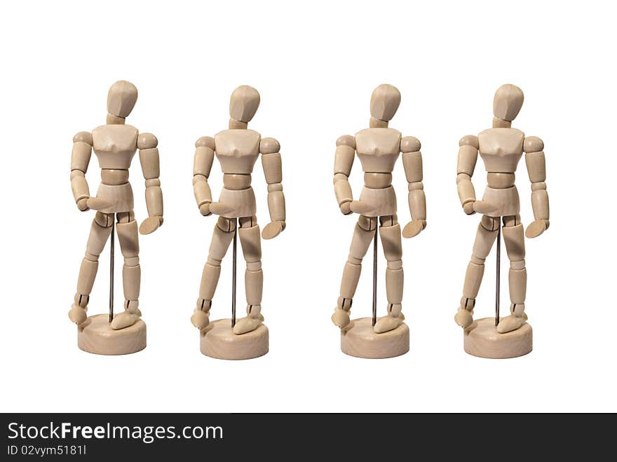 Four Identical Wooden Artist Dummies in a Line-up Isolated on White. Four Identical Wooden Artist Dummies in a Line-up Isolated on White