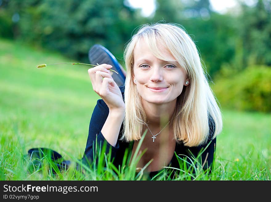 Girl relaxing on the meadow against