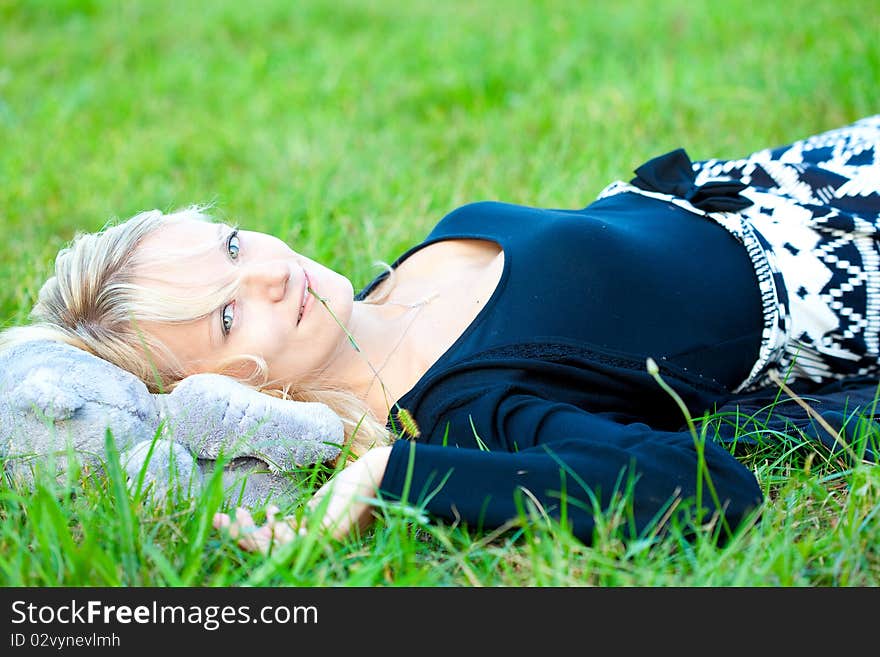 Girl relaxing on the meadow against