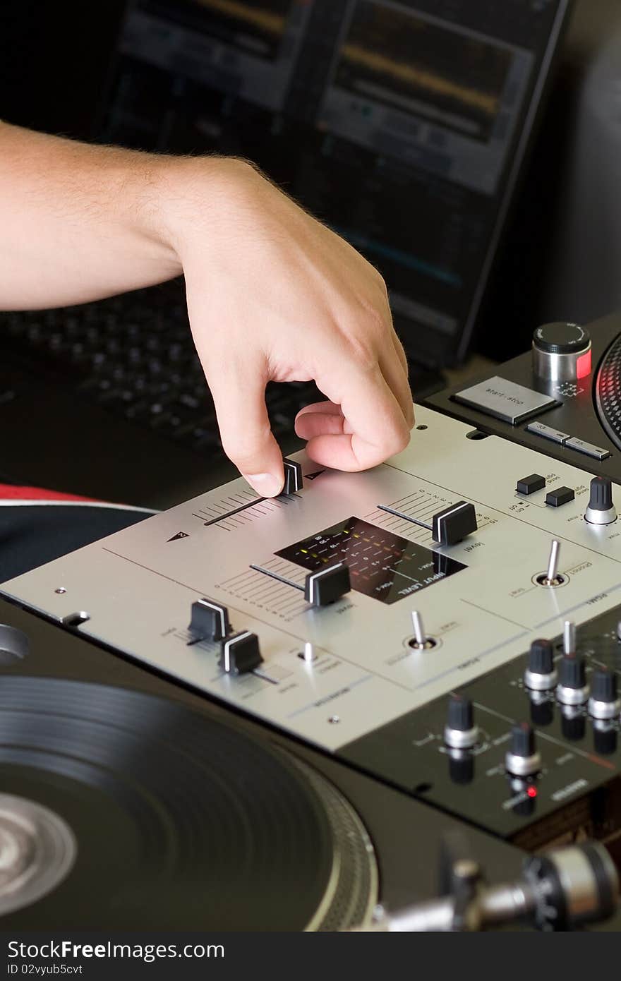 Hand of a disc jockey on the professional mixing controller. Hand of a disc jockey on the professional mixing controller