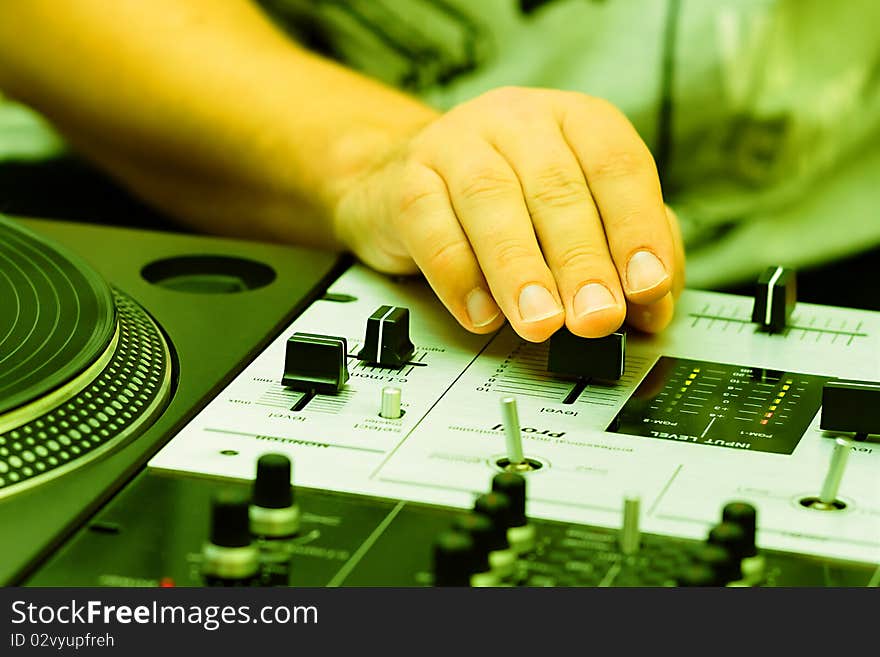 Hand of a disc jockey on the professional mixing controller. Hand of a disc jockey on the professional mixing controller