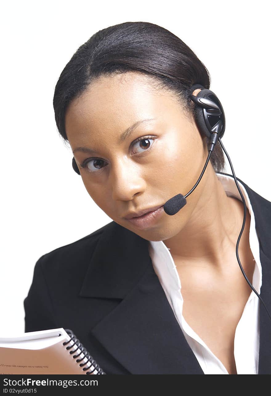 An african american business woman dressed formally uses a headset, isolated on white