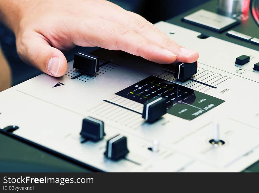 Hand of a dj adjusting the crossfader