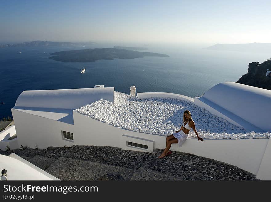 Young woman admires the sunset in Santorini, Greece. Young woman admires the sunset in Santorini, Greece