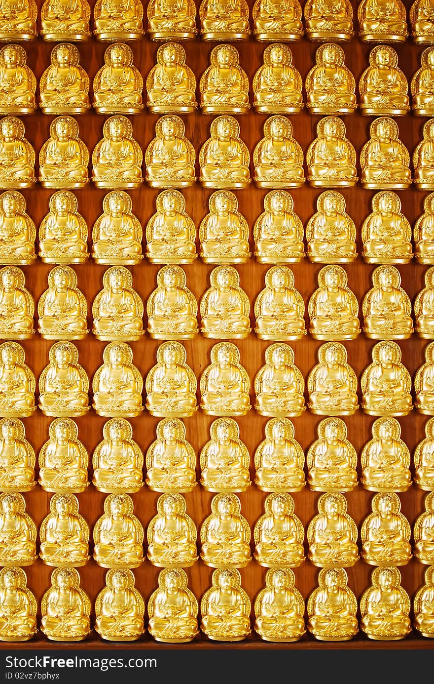 Many of Golden Buddha Statue on wooden wall in Chinese Temple