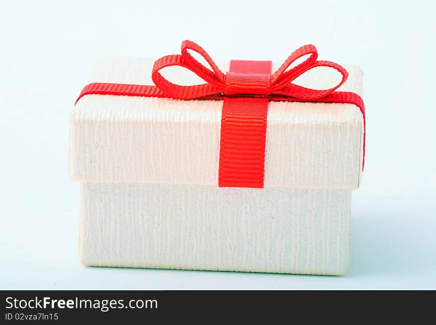 White gift box with red ribbon