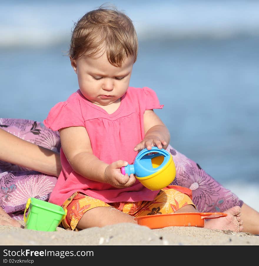 Girl playing toys in the sand