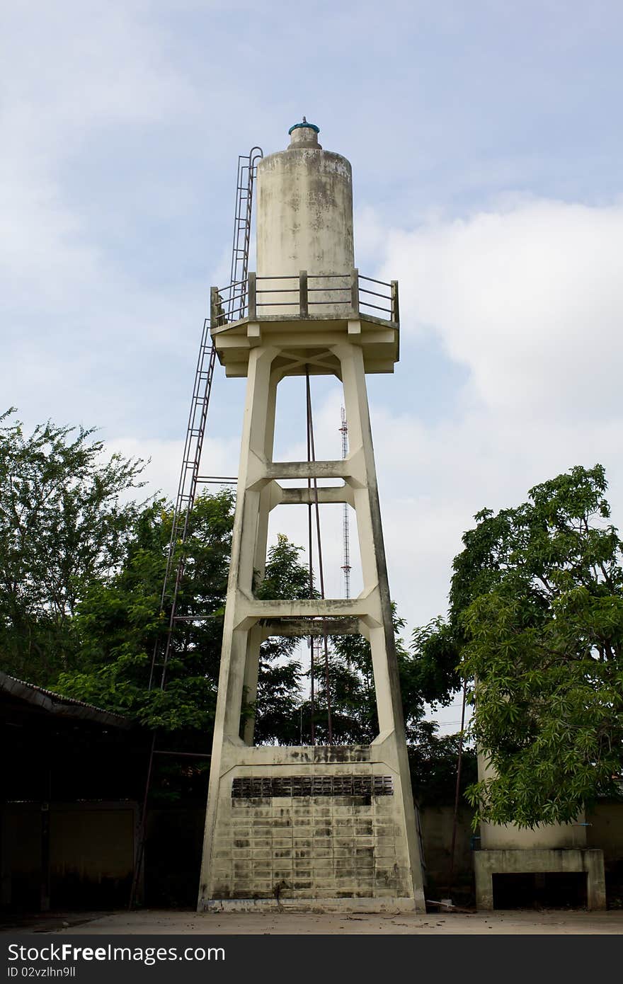 Old abandoned industrial water tower with reservoir tank in factory