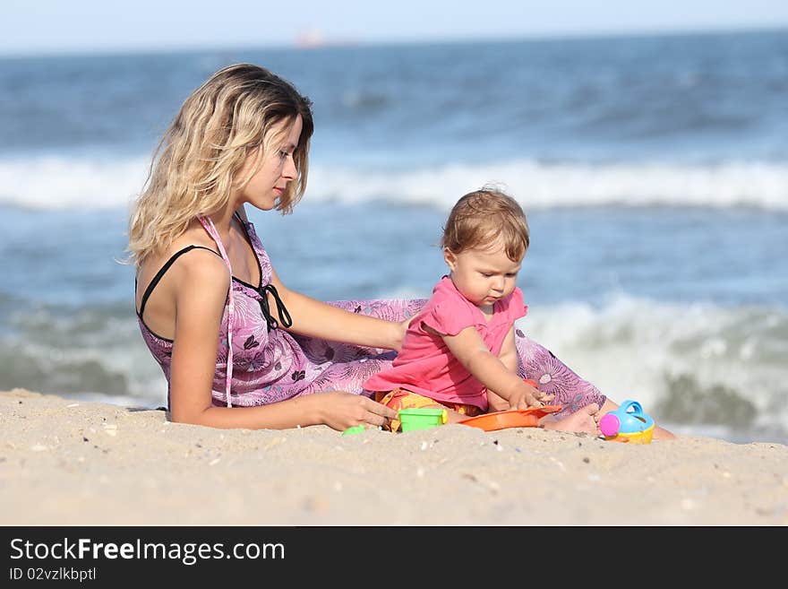 Mom with a child playing in the sand