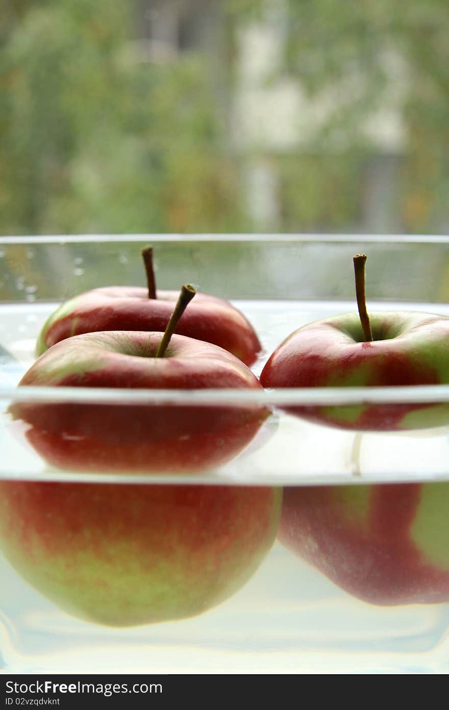 three apples for the glass cup of water. three apples for the glass cup of water