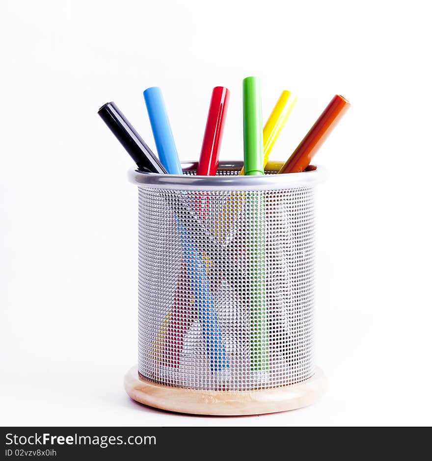 Black metal pencil cup filled with colorful pencils.