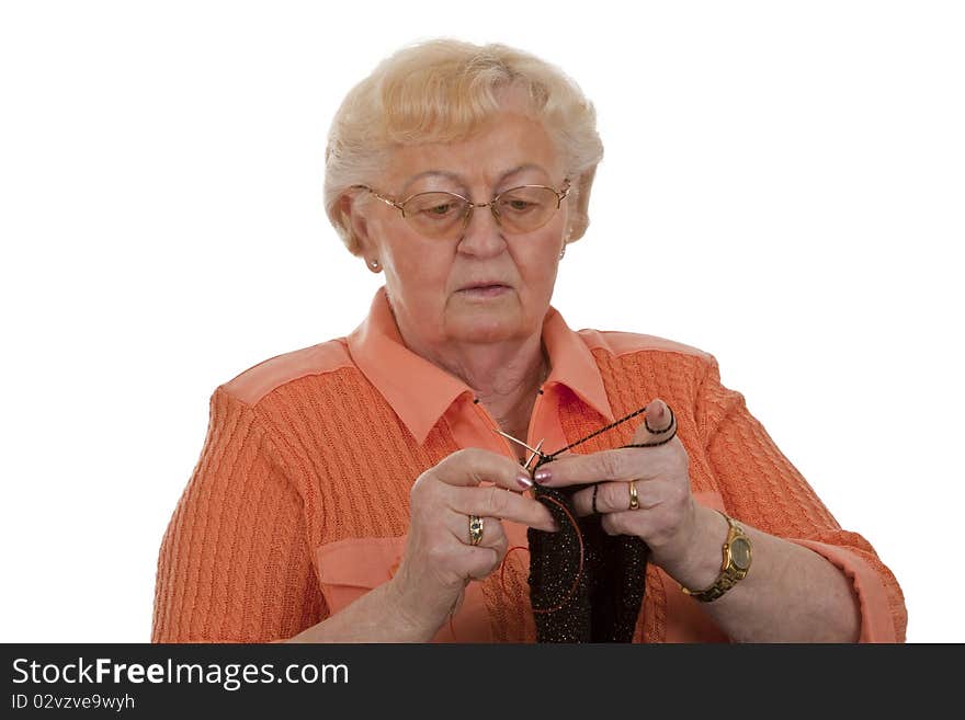 Old woman senior is knitting-isolated on white background