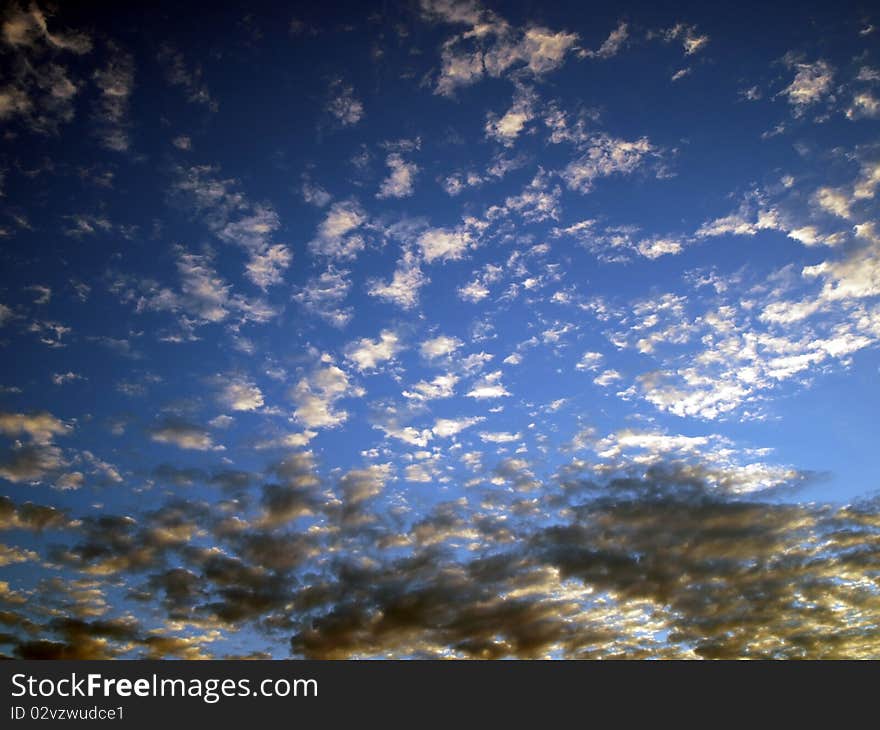 Blue sky with black and white clouds