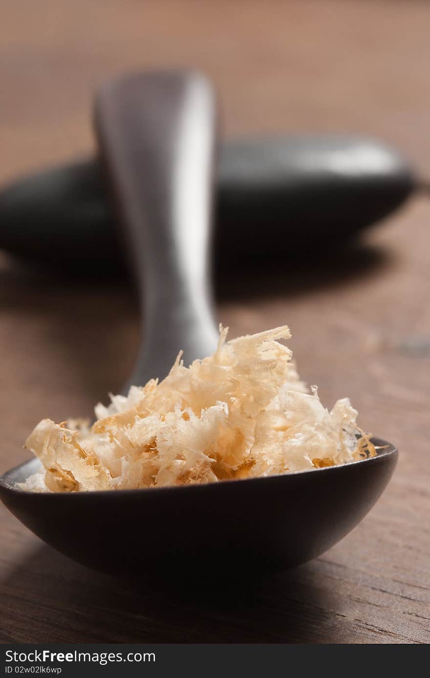 Tuna flakes in a wood spoon