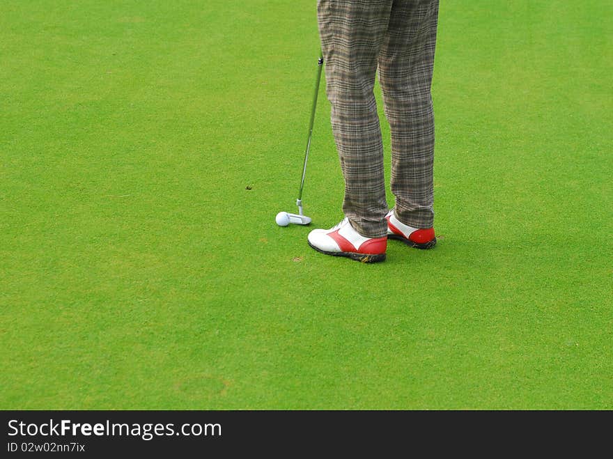 Golf ball on lip of cup of lovely beautiful golf course