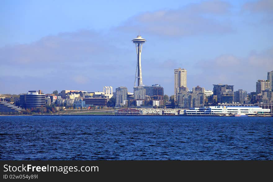 The Queen Anne district and the Seattle Space Needle tower from across the bay. The Queen Anne district and the Seattle Space Needle tower from across the bay.