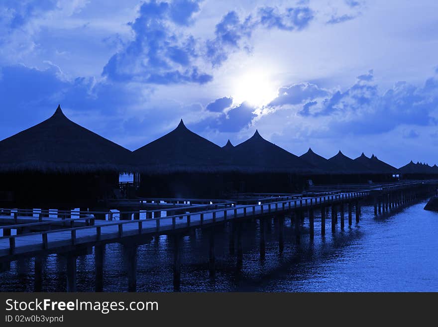 Water bungalows at night - abstract vacation background