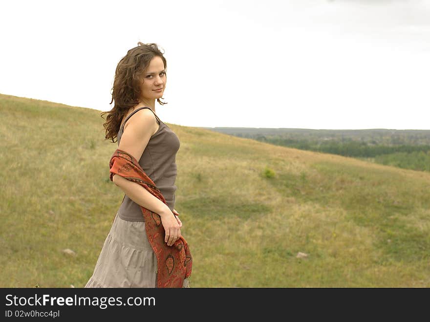 Charming girl standing on the hill