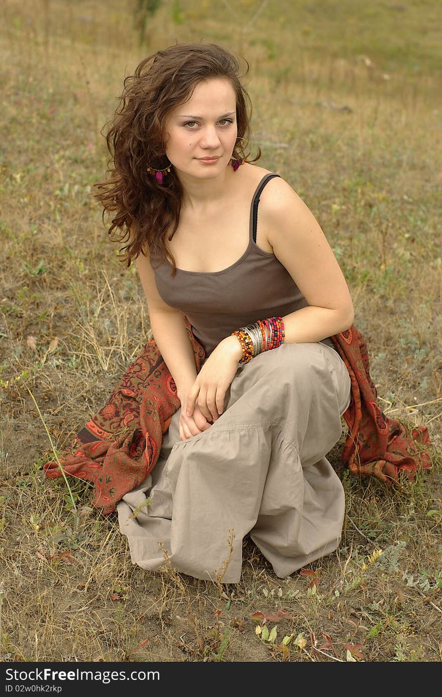 Female sitting in the autumn field