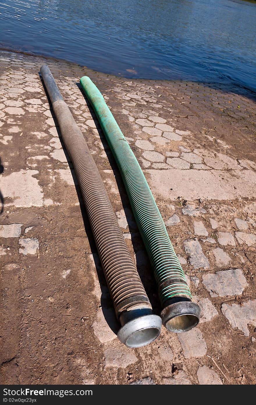 Flexible tubes for disposing liquid manure in the river. Flexible tubes for disposing liquid manure in the river